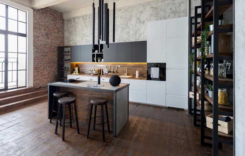 A modern industrial kitchen with a brick accent wall and an island.